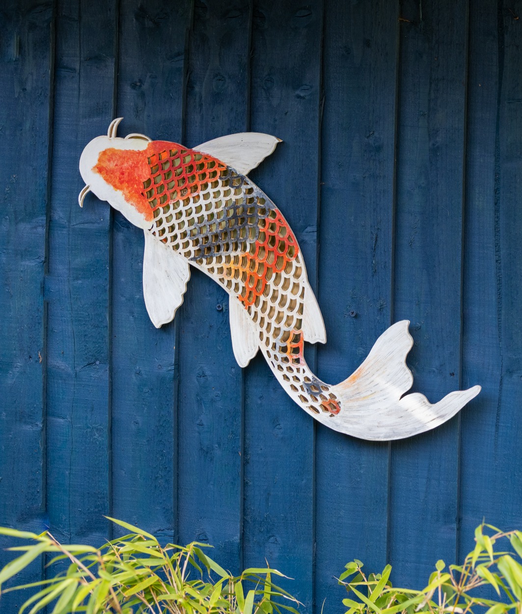 Showa koi laser-cut wall art on a blue timber wall